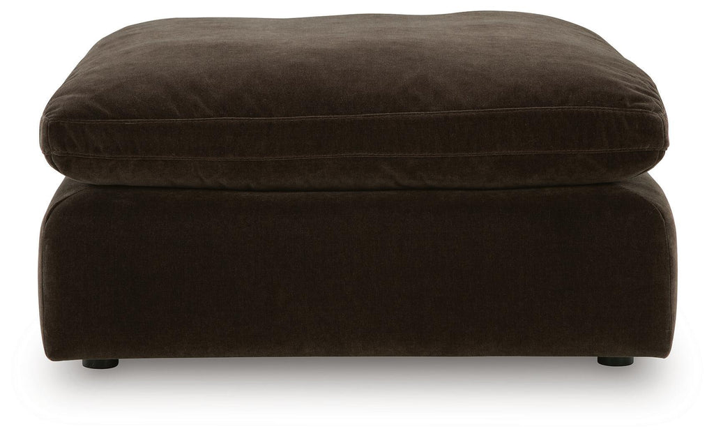 Oversized accent ottoman in dark brown, rounded top cushion and low legs
