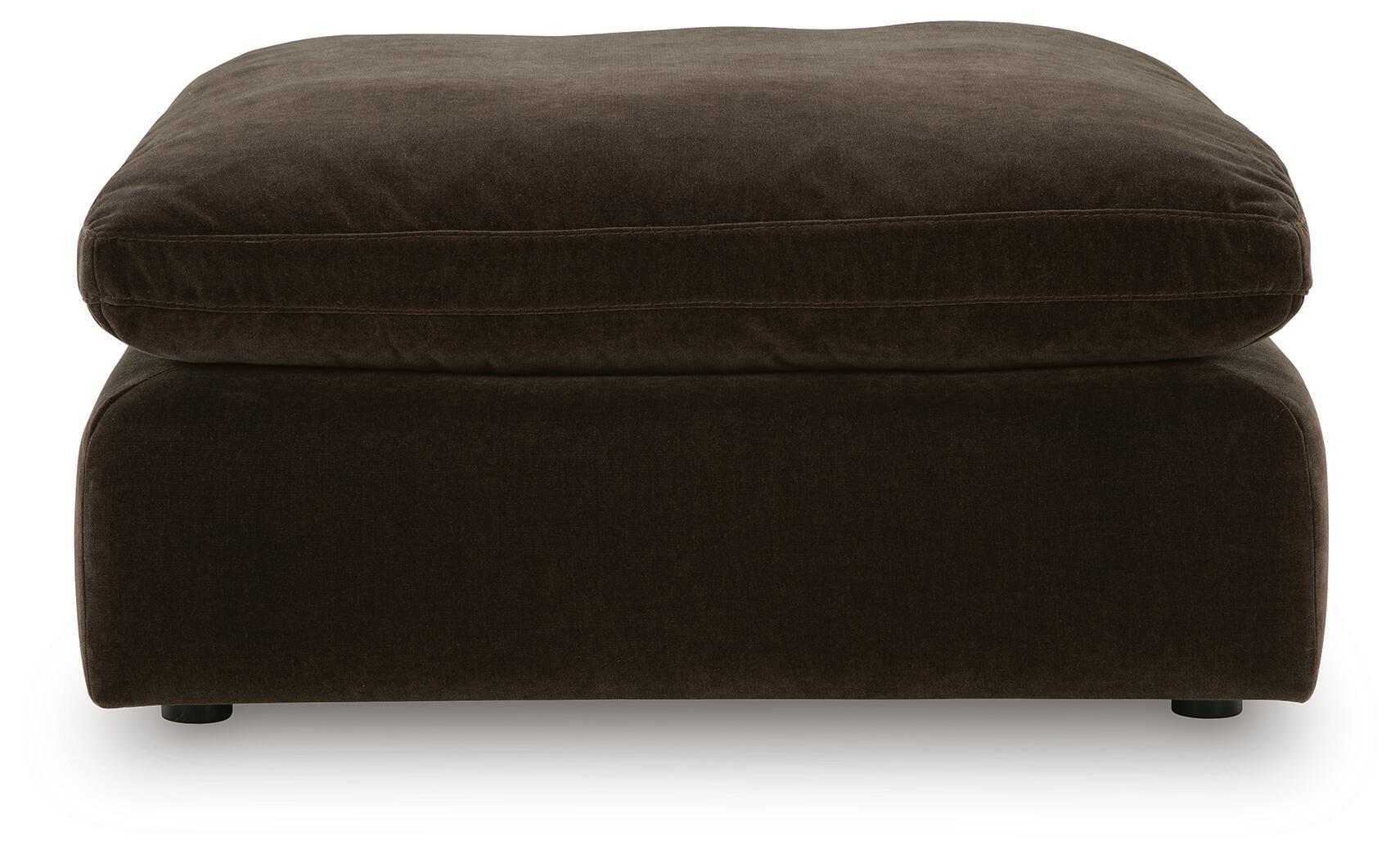 Oversized accent ottoman in dark brown, rounded top cushion and low legs