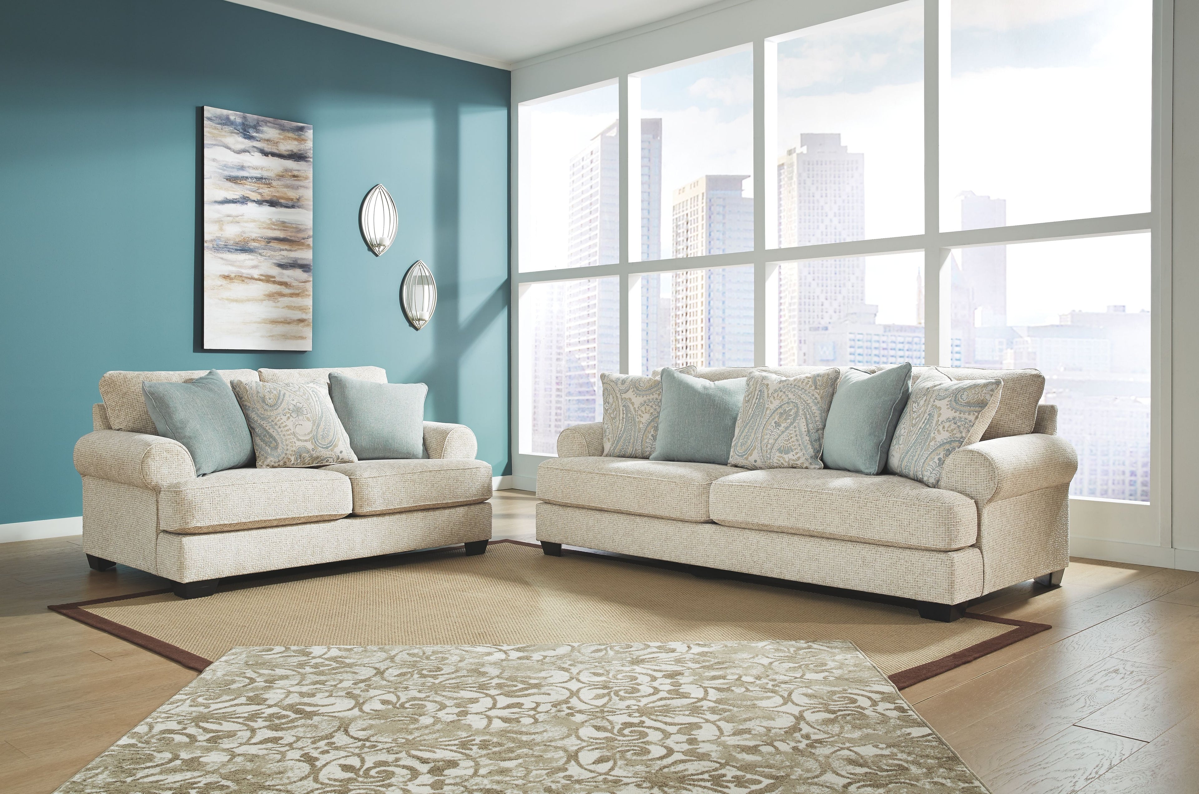 Upholstered seating set with two light beige sofas and blue accent pillows