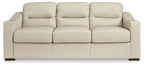Almond upholstered sofa with three back cushions, three seat sections, and black feet