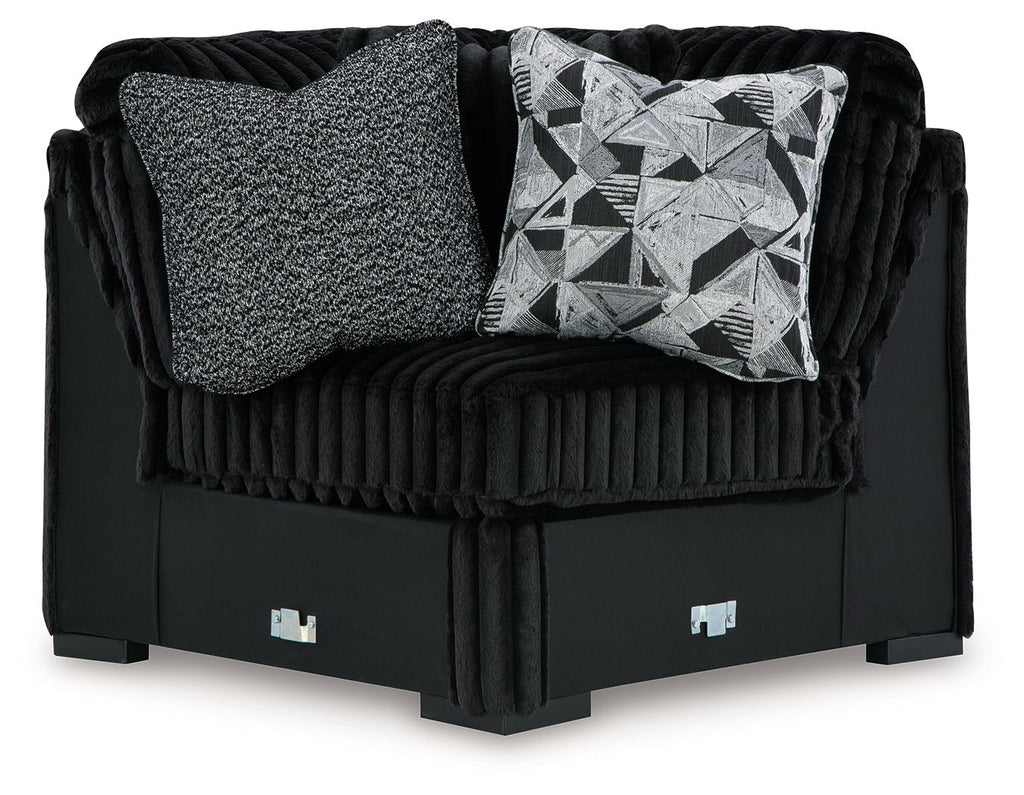 Black wedge sofa with ribbed fabric, gray and geometric accent cushions
