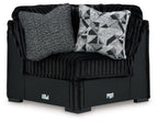 Black wedge sofa with ribbed fabric, gray and geometric accent cushions