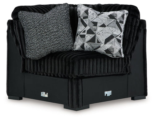 Black wedge sofa with ribbed fabric, gray and geometric accent cushions