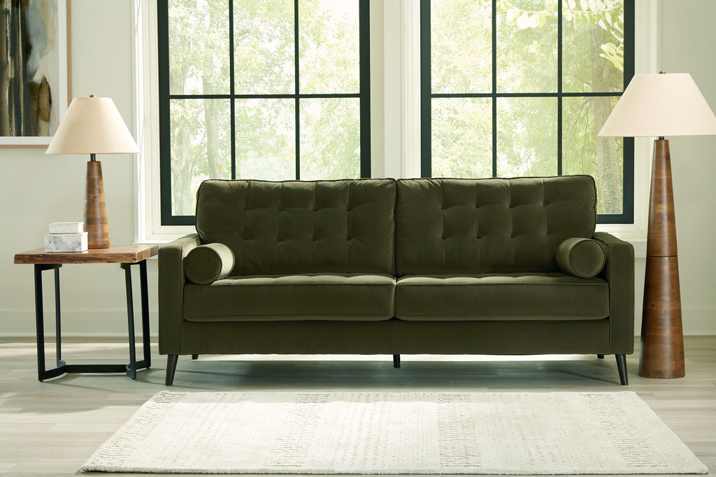 Olive green tufted sofa with rolled arms and two seat cushions.