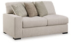 Sand-tone upholstered loveseat with two seat cushions and four patterned throw pillows