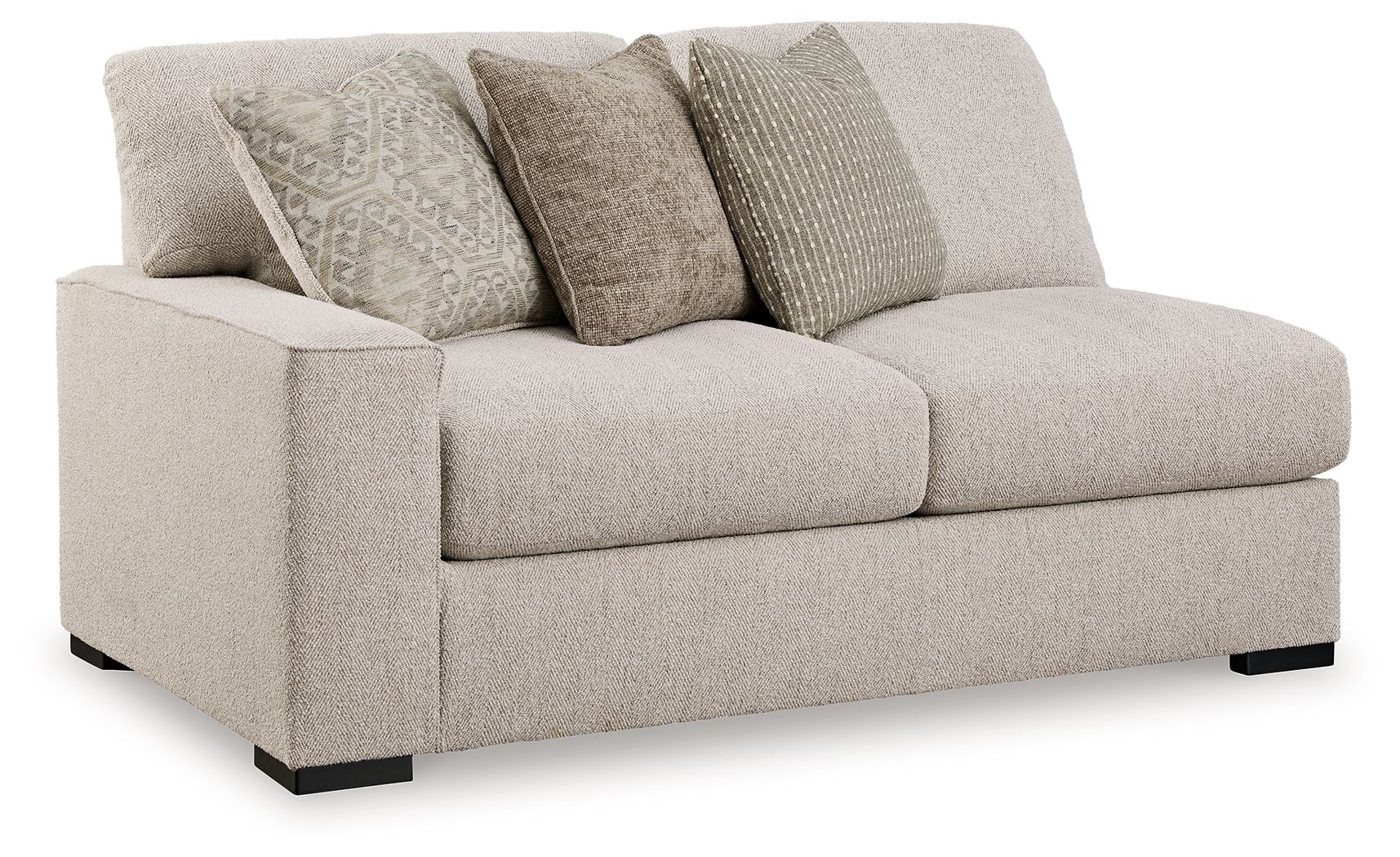 Sand-tone upholstered loveseat with two seat cushions and four patterned throw pillows