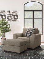 Beige fabric sectional chaise with geometric check throw pillow and ottoman-style seat