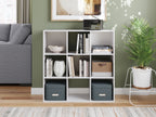 White cube organizer with 9 open cubbies, books and fabric bins displayed inside