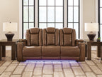 Brown power reclining sofa with three padded headrests and low-profile arm controls