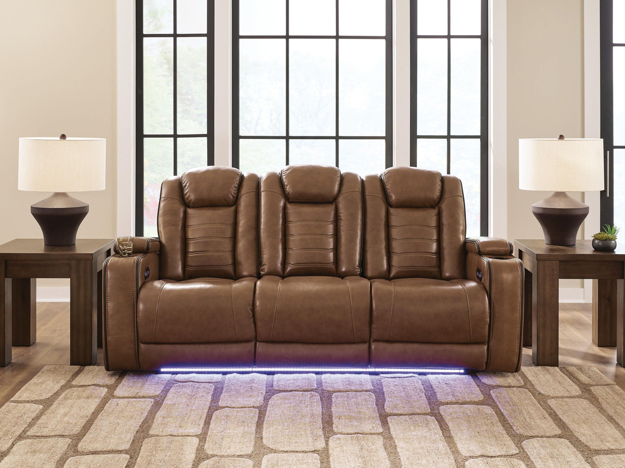 Brown power reclining sofa with three padded headrests and low-profile arm controls
