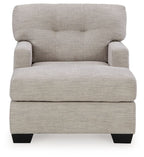 Pearl silver upholstered chaise chair with tufted back, cushioned seat, and black feet