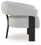 Gray upholstered accent chair with curved back, rounded arms, and dark legs