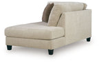 Beige corner chaise with thick seat cushion, dark legs, and one back pillow