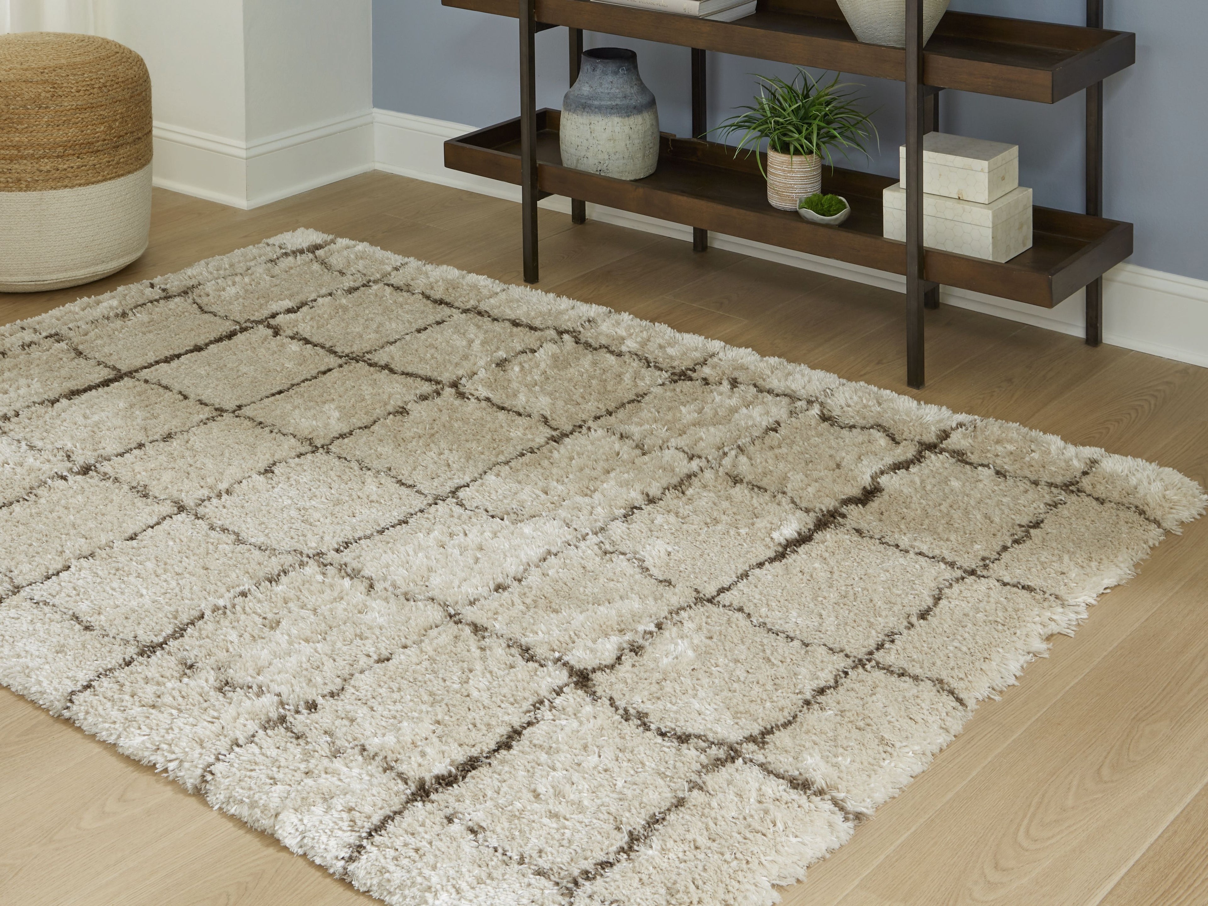 Beige rug with low-pile shag texture and overlapping grid pattern