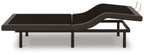Adjustable bed base in black fabric with raised head section and metal frame