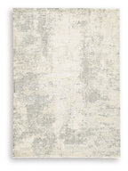 Cream area rug with scattered gray motifs and distressed, low-pile texture