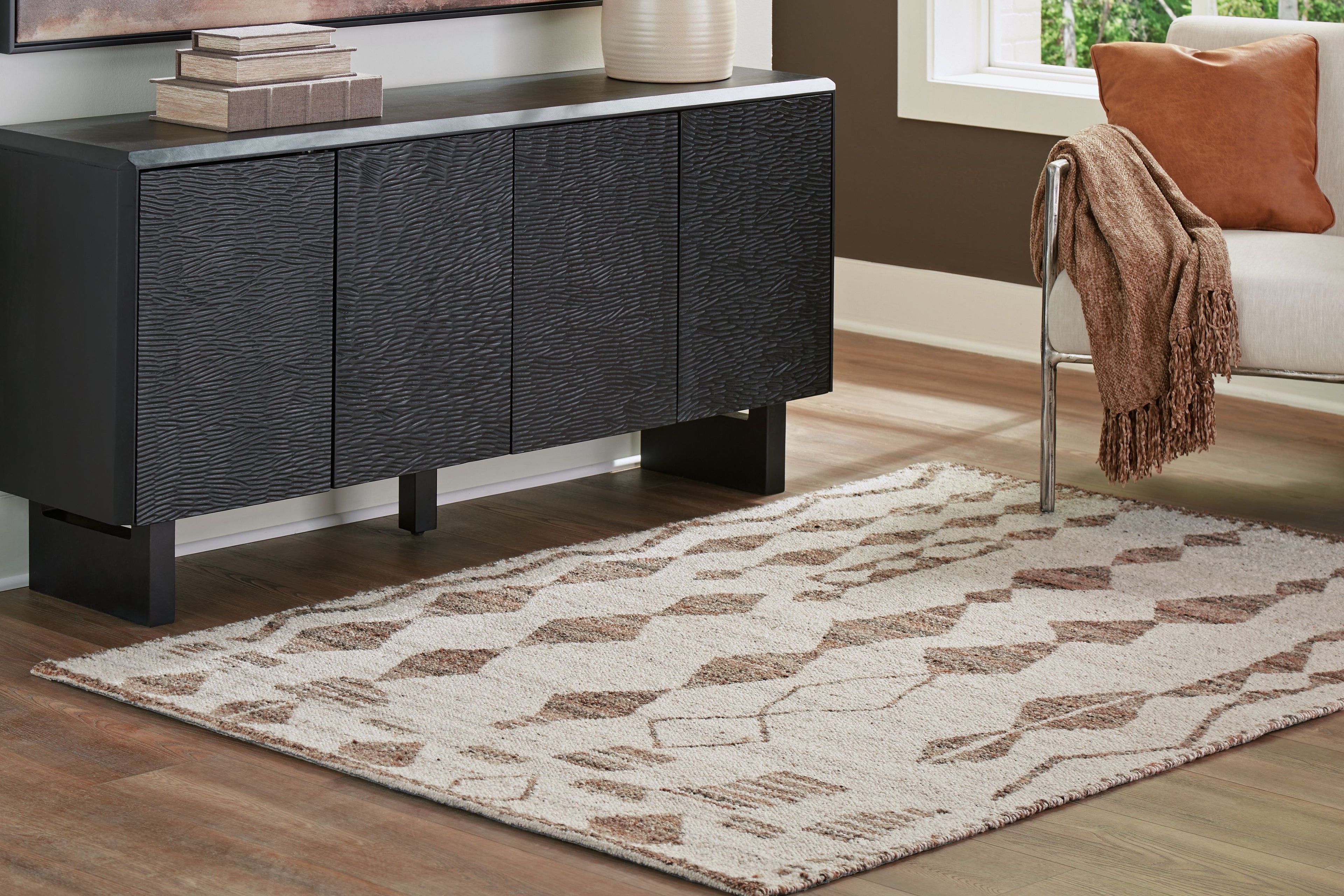 Geometric area rug with ivory base and dark brown grid diamond pattern, textured weave