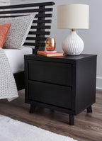Black two-drawer night stand with flat top, centered drawers, and four dark legs