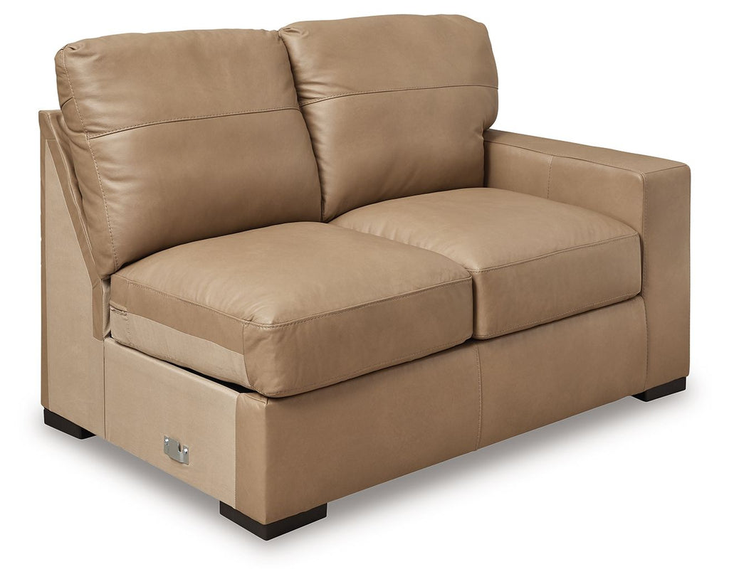 Toffee-brown leather loveseat with two seat cushions, back pillows, and side armrests