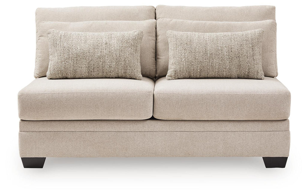 Armless loveseat with light beige upholstery, two back cushions, and dark legs