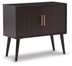 Dark wood accent cabinet with two doors and gold bar pulls, raised on legs