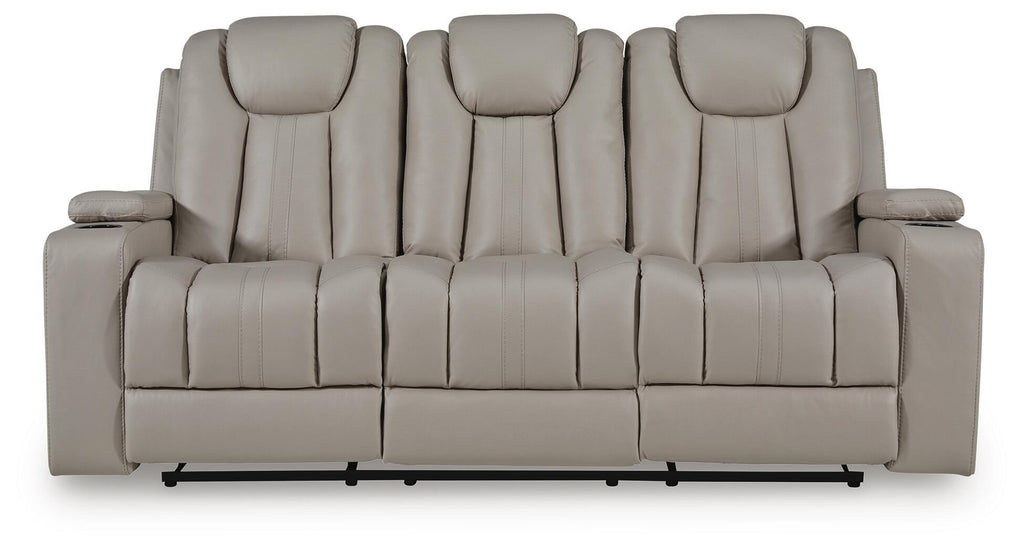 Reclining sofa back view with five padded seat sections and light beige upholstery