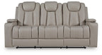 Reclining sofa back view with five padded seat sections and light beige upholstery