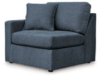 Ink blue fabric corner chair with curved arms, rounded seat, and supportive back cushions.