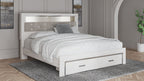 White king upholstered bookcase bed with low footboard and two storage drawers
