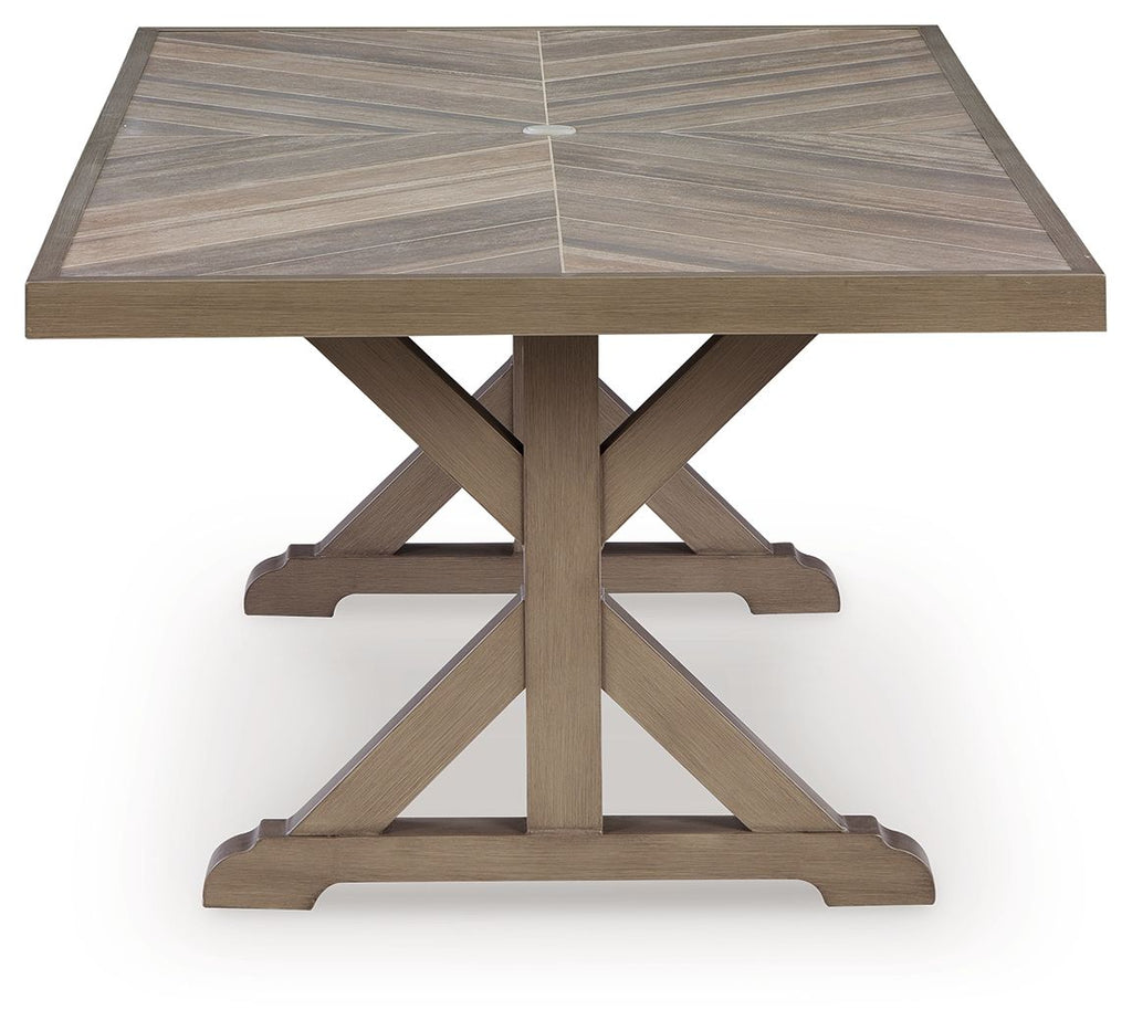 Rectangular dining table with umbrella opening, beige slatted top and X base with pole.