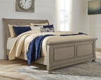 Lettner sleigh bed with two drawers, gray wood frame and blue-and-cream bedding