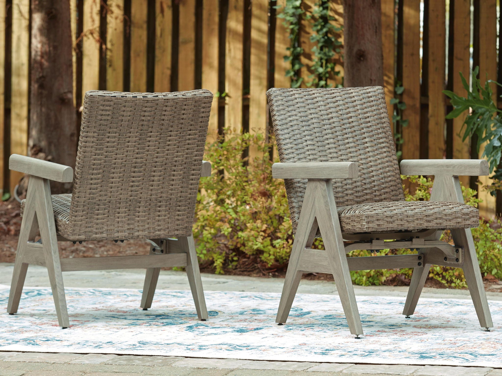 Beige woven rocking arm chairs, set of 2, with slatted armrests and angled legs