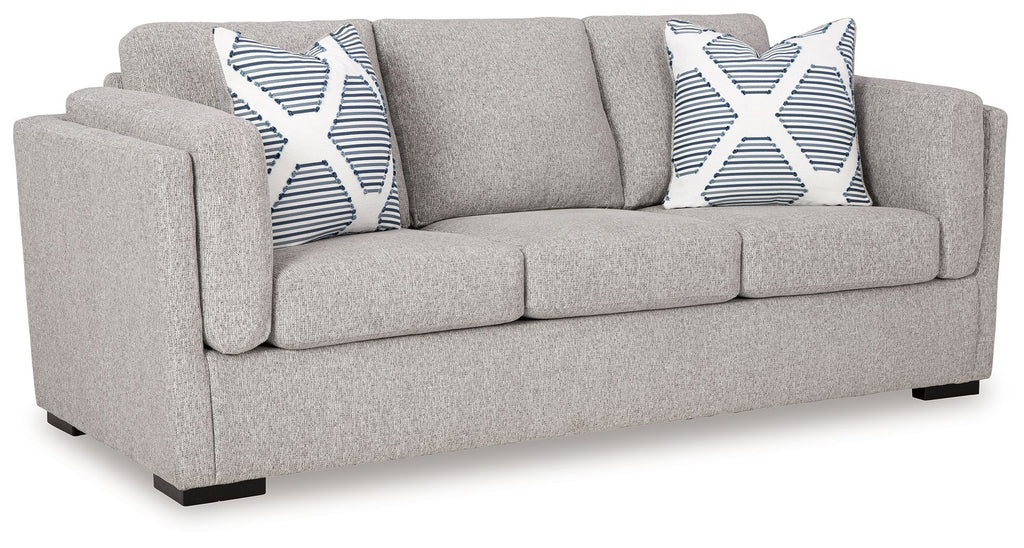 Light gray upholstered loveseat with two striped accent pillows