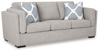 Light gray upholstered loveseat with two striped accent pillows