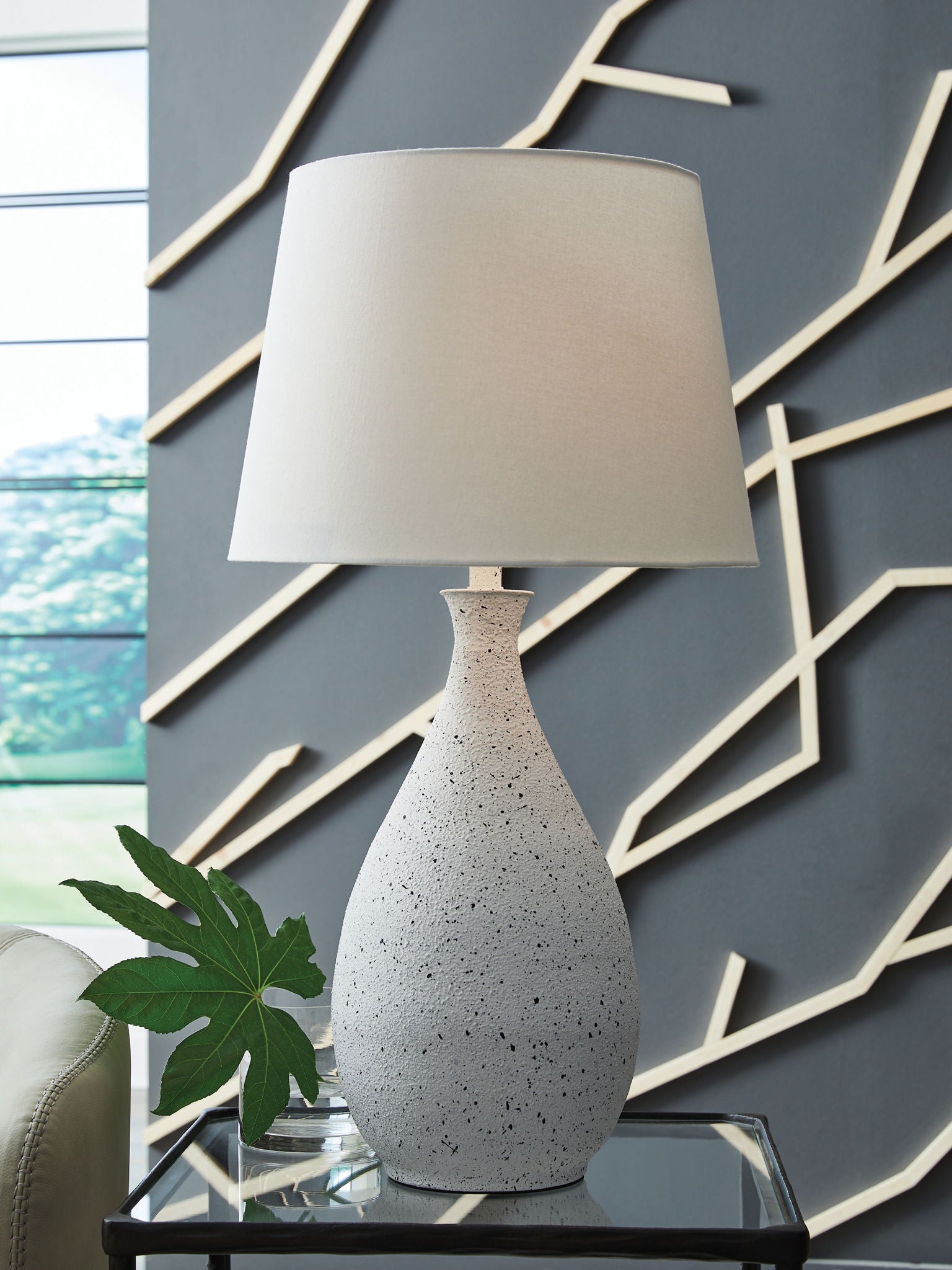 White drum table lamp shade on speckled white metal base