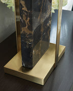 Black marble table lamp with gold base and frame, close-up of marble column