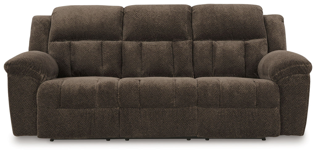 Reclining sofa in dark brown fabric with tufted back panel and wide padded arms