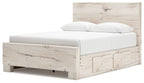 Panel bed with storage, white mattress and pillows, light wood footboard with drawer