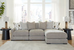 Light gray sofa sectional with ottoman-style chaise and geometric accent pillows