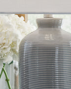Close-up of gray blue ribbed ceramic lamp base with narrow neck