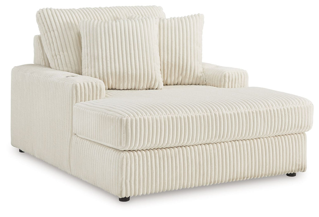 Corduroy chaise lounge chair in off-white with tall back cushions and wide armrests.