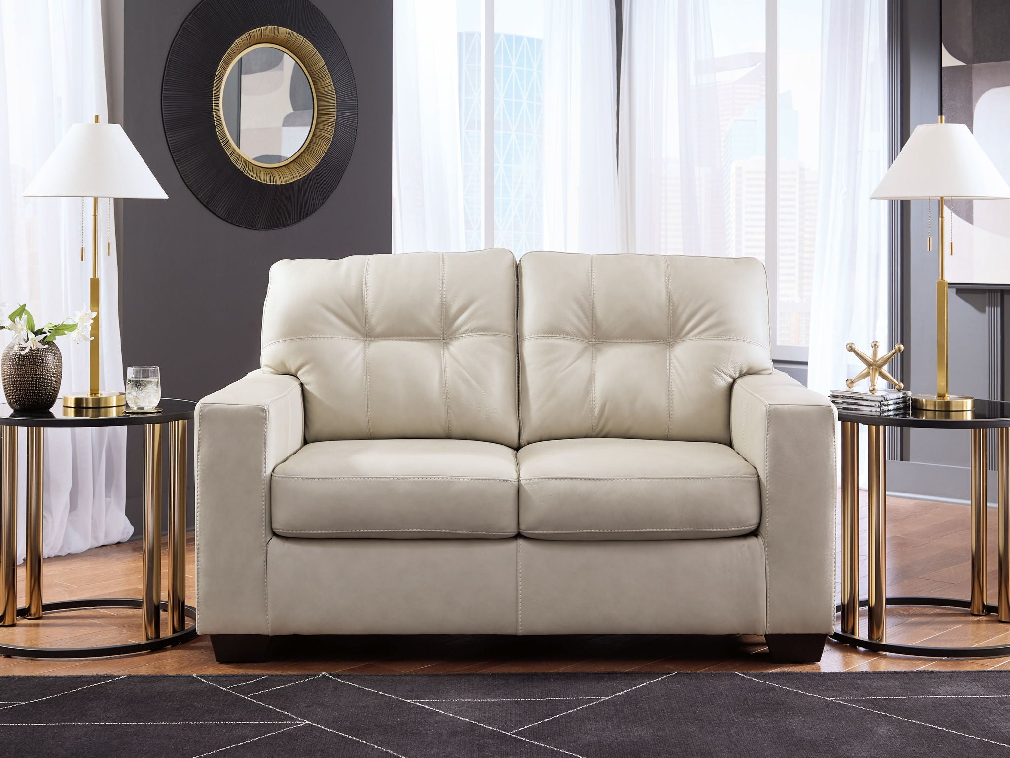 Light beige leather-look loveseat with tufted backrest, cushioned arms, and split seats