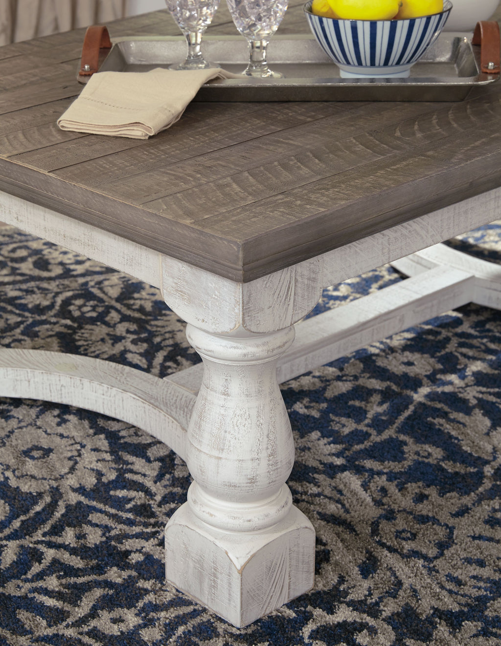 Rectangular cocktail table corner detail, gray surface with white base