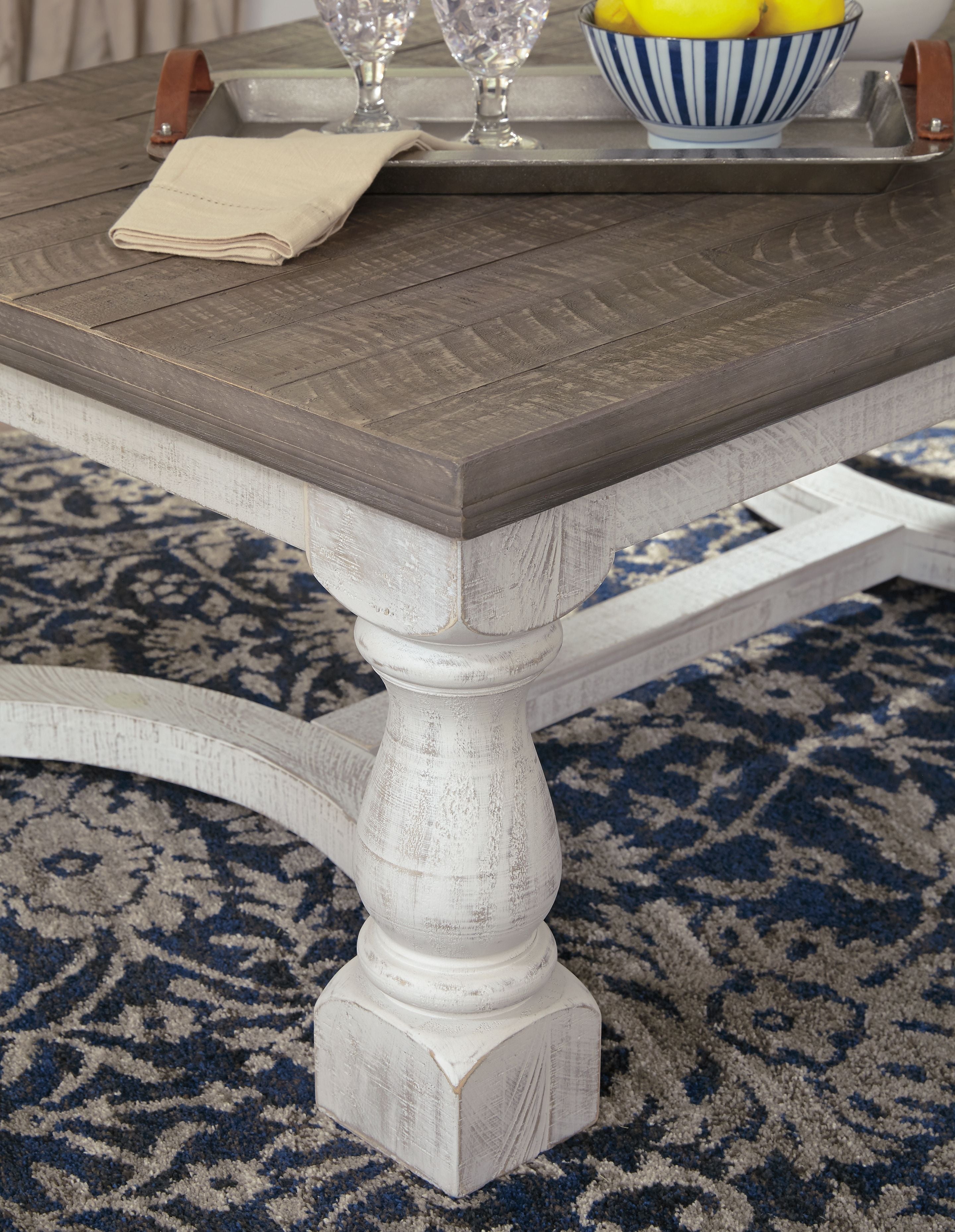 Rectangular cocktail table corner detail, gray surface with white base
