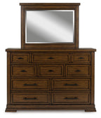Medium brown dresser and mirror with nine drawers and dark metal pulls