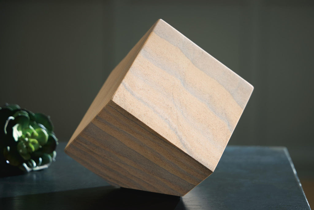 Tan wood sculpture block with blue-gray striped grain, angled view