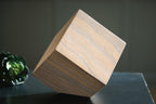 Tan wood sculpture block with blue-gray striped grain, angled view