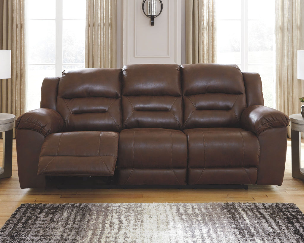 Chocolate-brown power reclining sofa with triple seat and padded armrests.