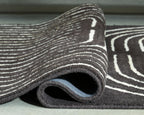 Eldonmore rug close-up: dark pile with white outline stripe pattern on edge.