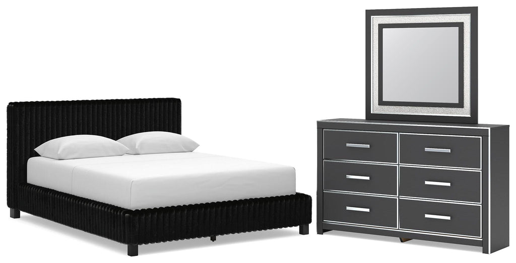 Black upholstered bed with two nightstands and wide dresser with framed mirror